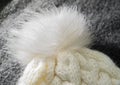 Handmade white pompon on top of the hat close-up