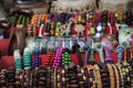 Handmade women's bracelets made of wooden and metal beads of different colors at a flea market showcase. Royalty Free Stock Photo