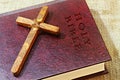 Handmade wood Christian Cross symbol of Christianity and vintage book Holy Bible in English. Christian religion concept Royalty Free Stock Photo