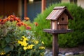 handmade wooden birdhouse on a pole