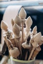 Handmade wooden spindles stand in a glass in a workshop Royalty Free Stock Photo