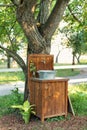 Handmade wooden Wash basin with soap in garden for hands cleaning in summer. Hand outdoor washing facilities to prevent the spread Royalty Free Stock Photo