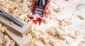 woodwork: a small red plane and chisel on the boards in shavings Royalty Free Stock Photo