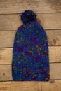 Handmade wool knitted winter colorful on wood background