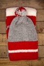 Handmade wool knitted winter red and grey hat and scarf Royalty Free Stock Photo