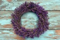 A handmade wreath of lavender on an old blue wall.