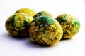 Handmade yellow green easter eggs painted marbled over white background