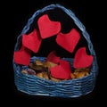 Handmaid basket with origami hearts for Saint Valentine`s Day on black background