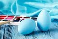 Handmaid blue paint easter egg on table with scarf