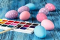 Handmaid blue paint easter egg on table with scarf Royalty Free Stock Photo