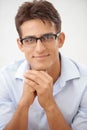 Handome AND intelligent. Portrait of a handsome young businessman wearing glasses smiling at the camera. Royalty Free Stock Photo