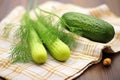 handpicked dill and cucumber on rustic cloth