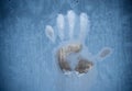 Handprint on a frozen window