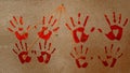 handprints of red, bloody color, on a cork board Royalty Free Stock Photo