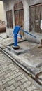A handpump in a village of blue color Royalty Free Stock Photo