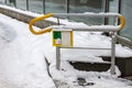 Handrail with button to help disabled people. Around lies snow Royalty Free Stock Photo