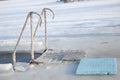 Handrail in ice to enter the ice hole at Epiphany in Ukraine Royalty Free Stock Photo