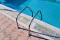 Handrail on the pool. Swimming pool with stair closeup. Royalty Free Stock Photo