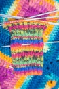 Handrcrafted colorful rainbow scarf beginned to knitting above Royalty Free Stock Photo