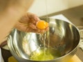 Hands add egg in a bowl Royalty Free Stock Photo