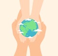 Hands of an adult and a child holding together the planet Earth in their palms, top view Royalty Free Stock Photo