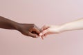 the hands of an African American and a European touch each other. themes relationships, diversity race