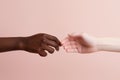 the hands of an African American and a European touch each other. themes relationships, diversity race