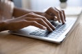 Hands of African American woman typing on laptop keyboard Royalty Free Stock Photo