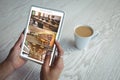 Hands of african american woman using tablet with view of library from security cameras on screen