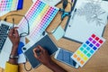 Hands of afro american woman in a stylish yellow jacket and multi-colored dreadlocks pigtails is graphic designer draws Royalty Free Stock Photo