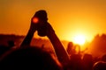 Hands in the air on party concert on summer festival - someone holding bank of beer in the air Royalty Free Stock Photo