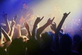 Hands in air, people dancing at concert or music festival with neon lights and energy at live event. Dance, fun and Royalty Free Stock Photo