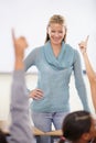 Hands in the air, woman and questions with students, teacher and knowledge in a classroom. School, educator and kids Royalty Free Stock Photo