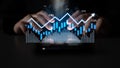 Hands Analyzing Data on a Tablet with Financial Charts and Graphs Showing Growth and Trends in a Dark Environment Scalp Royalty Free Stock Photo