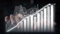Hands Analyzing Stock Market Trends with Graphs Showing Growth and Progression in Financial Data Visualizations Over a Royalty Free Stock Photo