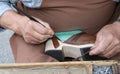 Hands of ancient cordwainer make shoe