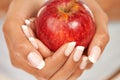 Hands, apple or food with a person closeup for health, diet or nutrition in the kitchen of her home. Fruit, nutritionist