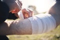 Hands, arm bandage and first aid after injury, workout or exercise accident outdoors. Medical emergency, help and