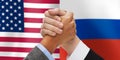 Hands armwrestling over american and russian flags