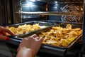 hands arranging chips for oven baking