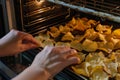 hands arranging chips for oven baking