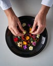 Hands arranging colorful flowers in bowl Royalty Free Stock Photo
