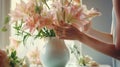 Hands arranging flowers in a vase by bright sunlight Royalty Free Stock Photo