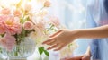 Hands arranging flowers in a vase by bright sunlight Royalty Free Stock Photo