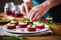 hands arranging goat cheese on beetroot slices