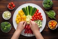 hands arranging skewered veggies on plate