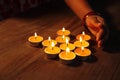 A girls hand arranging Tea lights candles Royalty Free Stock Photo