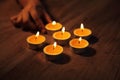 A hand arranging Tea lights candles Royalty Free Stock Photo