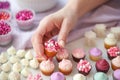 hands arranging a variety of mini cupcakes