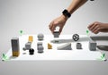 Hands arranging various 3d printed objects and prototypes on a white surface Royalty Free Stock Photo